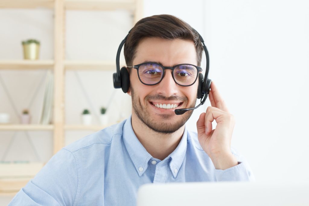 Portrait of young male technical support in call centre