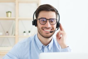 Portrait of young male technical support in call centre